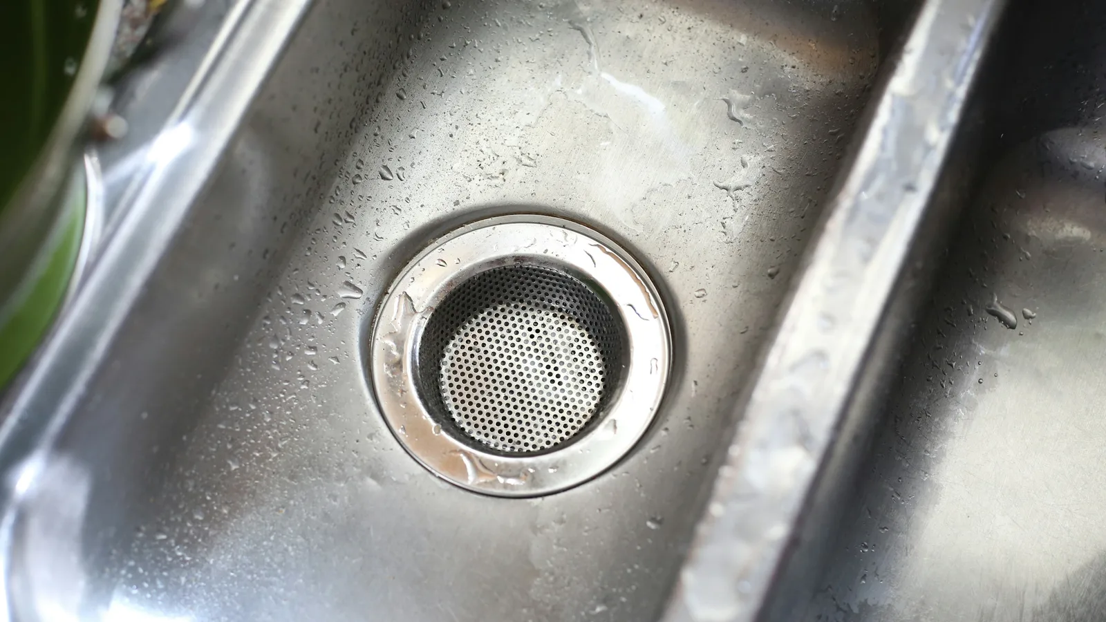 A kitchen sink drain, where grease and food waste cause most household blockages