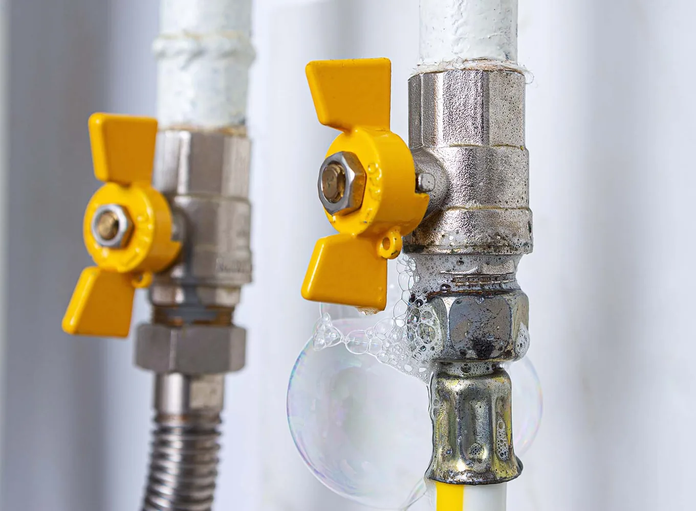 Leak detection solution bubbling at the joint below a yellow gas shut-off valve